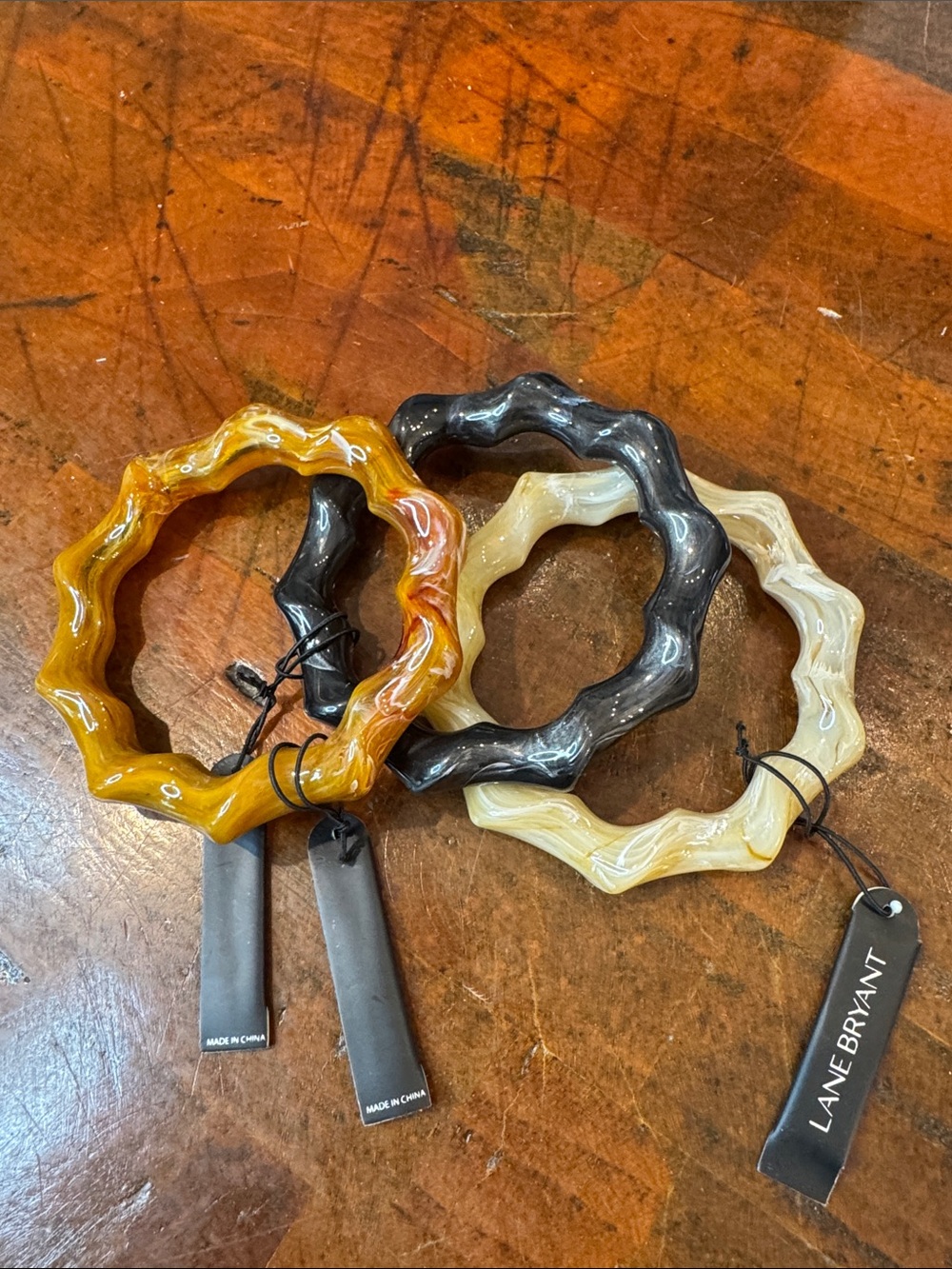 Lane Bryant Wavy Resin Bangles in Amber, Black, Cream